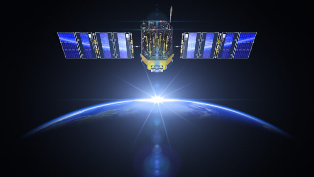 Satellite and sunrise in space