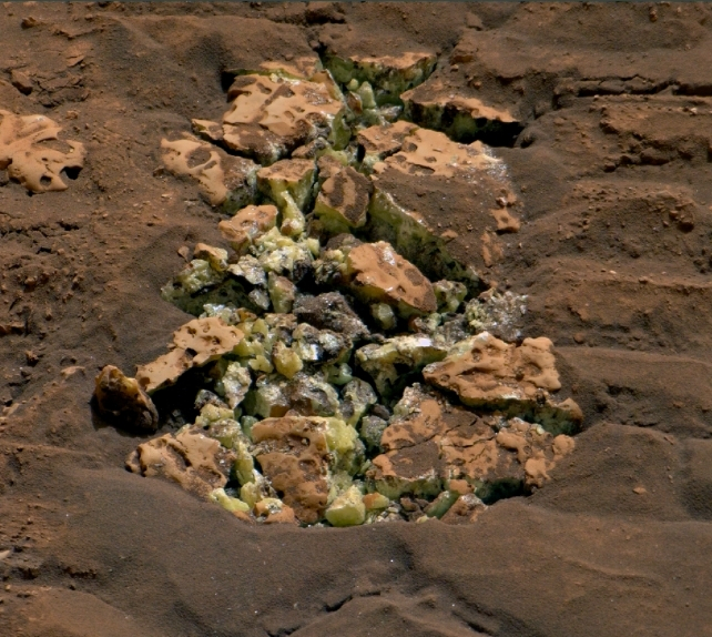 Yellow crystals that were revealed after NASA's Curiosity happened to drive over a rock and crack it open