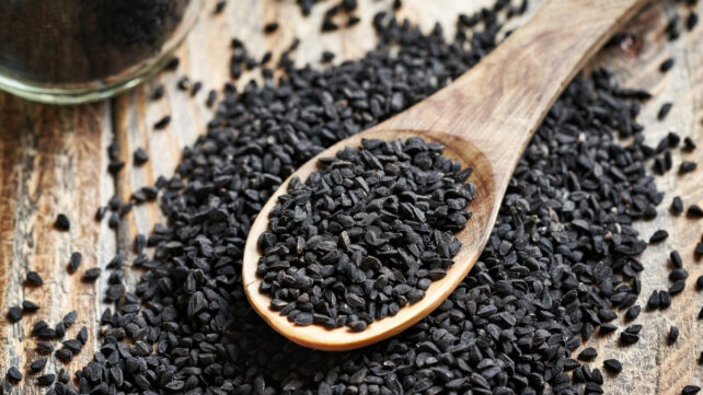 black cumin seeds on a wooden spoon
