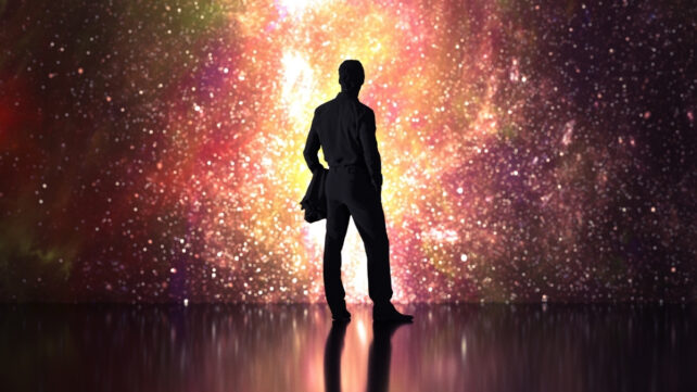 shadow of a man looking at a starry sky