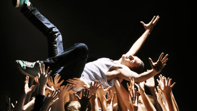 man carried by a crowd