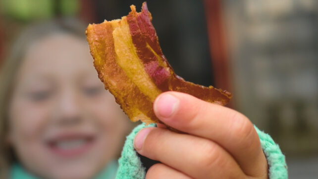 girl holding bacon