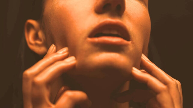 woman touching her face