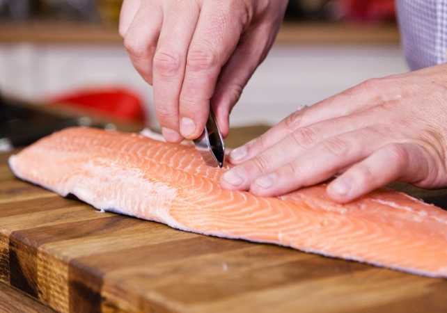 removing pin bones from a fillet of salmon