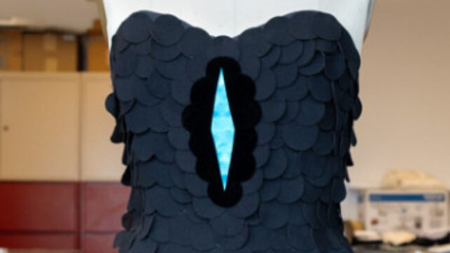 A black dress up close, with a diamond shaped section looking very dark black