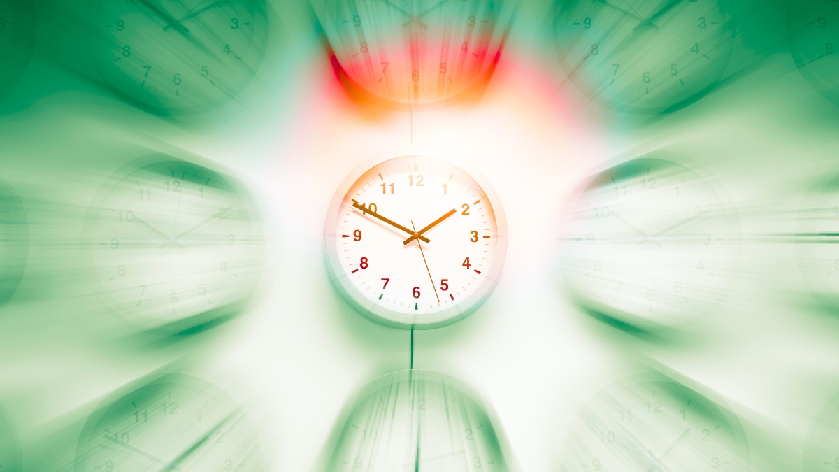A central clock in focus surrounded by blurred clocks