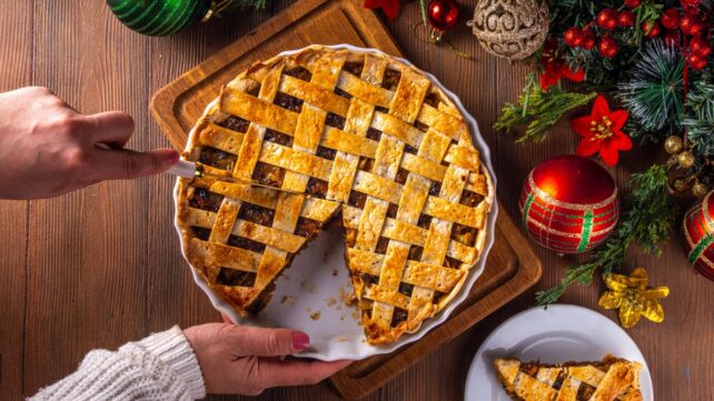 A christmas pie with a slice cut out of it