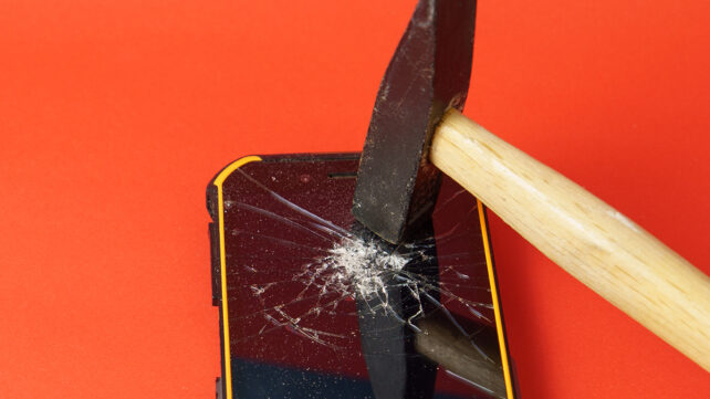 Hammer breaking the screen of a mobile phone