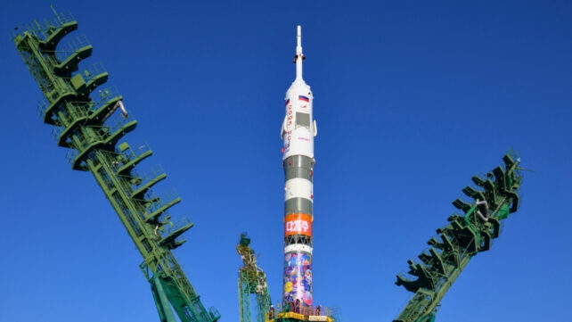A spacecraft on a launchpad against a bright blue sky
