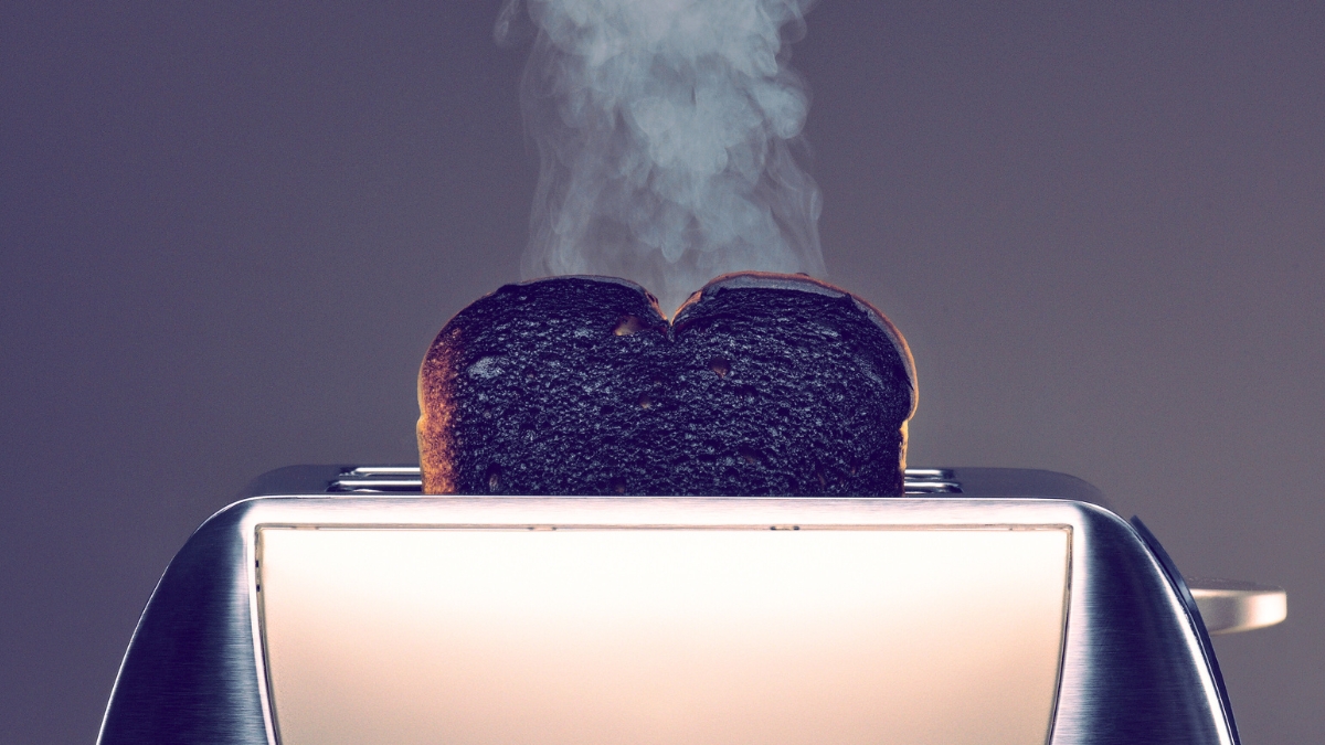 Toaster with one slice of smoking burned toast