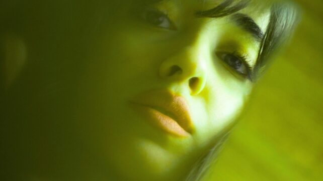 A woman's face with a green tint to it