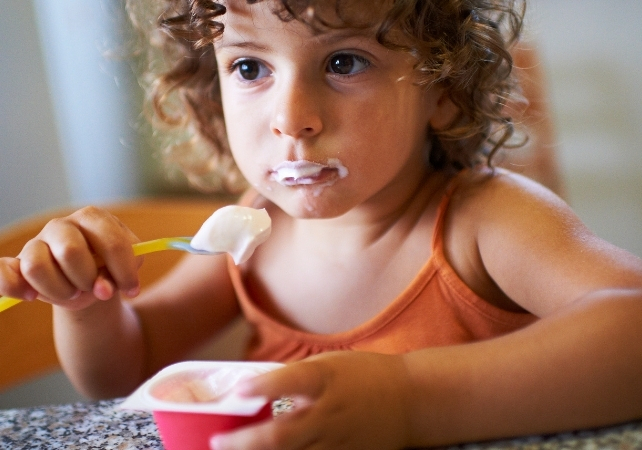 child eating yoghurt