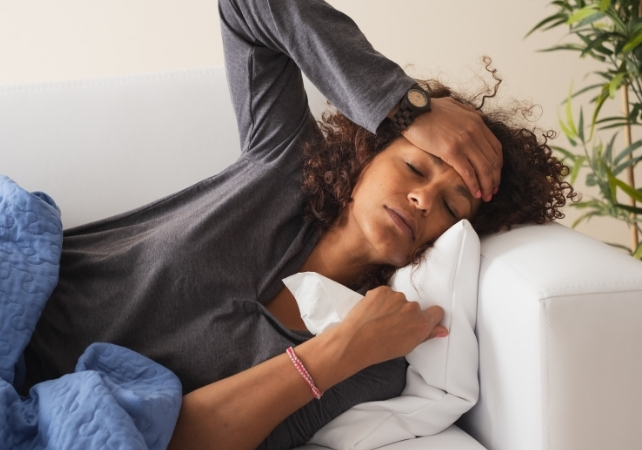 person with the flu on a couch