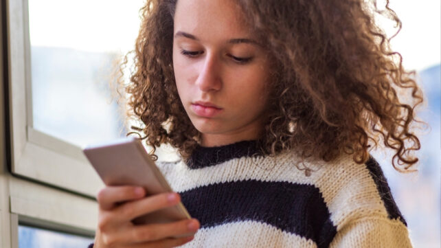 teenager on a cell phone