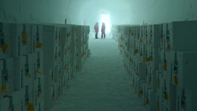 Two scientists standing at the end of a vault of ice