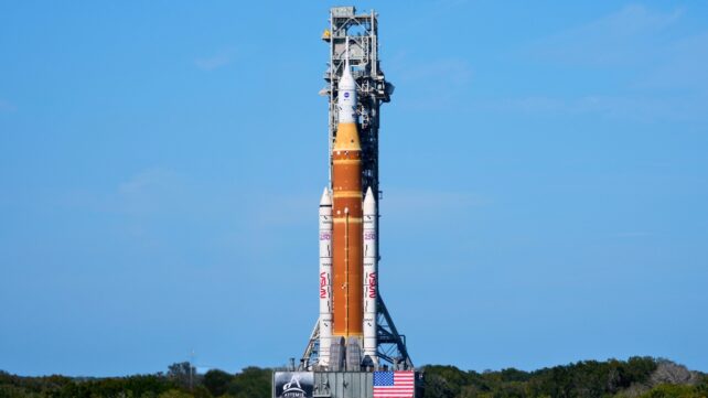 A giant NASA rocket against a bright blue sky