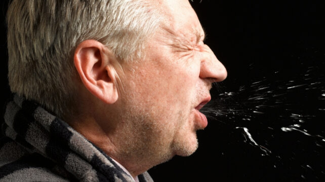 sick man sneezing
