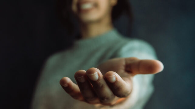 woman holding out her hand