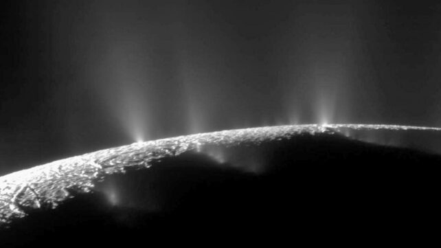The edge of a moon up close, with beams emanating from its surface
