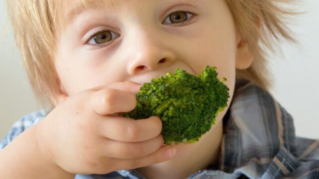 Child eating broccoli