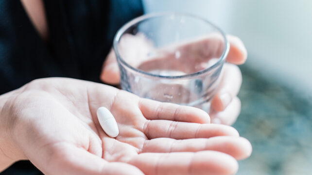A person taking a pill