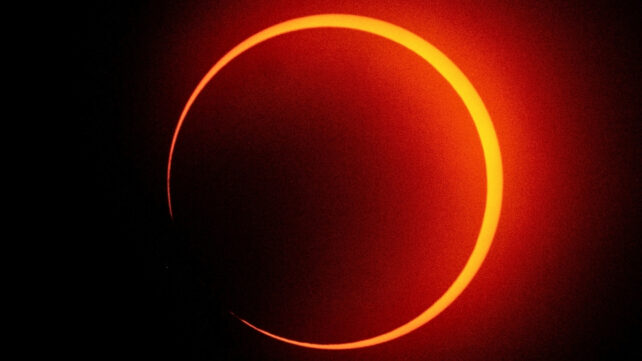 A solar eclipse appearing as ring of fire around the moon