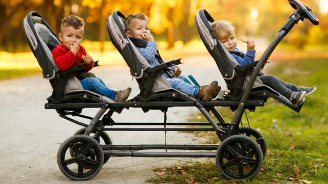 Triplets sat in a stroller
