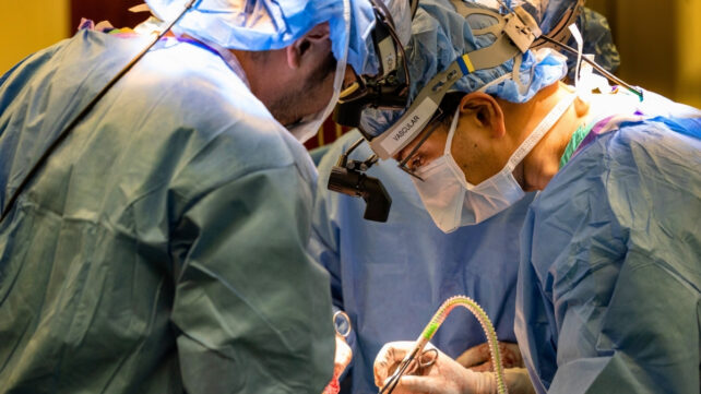 Close up of surgeons performing an unseen operation