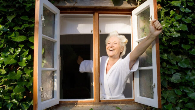 woman standing at an open window