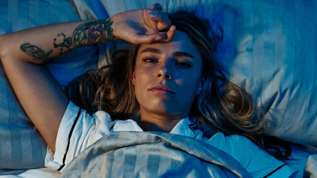 woman laying awake in bed