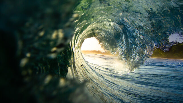 Inside view of a barrelling wave in the Caribbean at sunrise