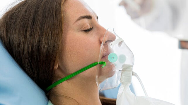 Woman using an oxygen mask