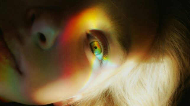 Close up of eye with light reflecting out of it