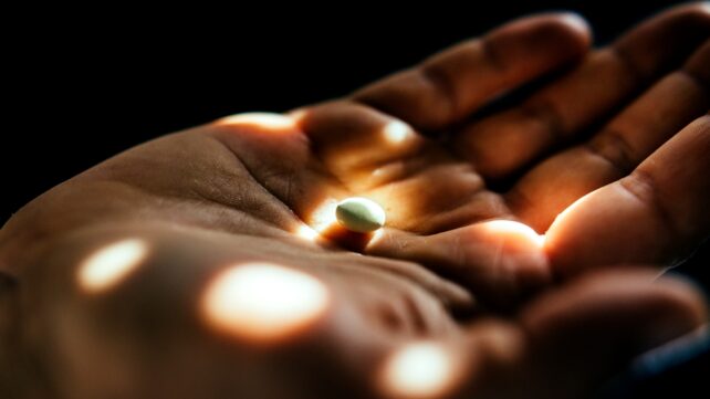 hand holding pill