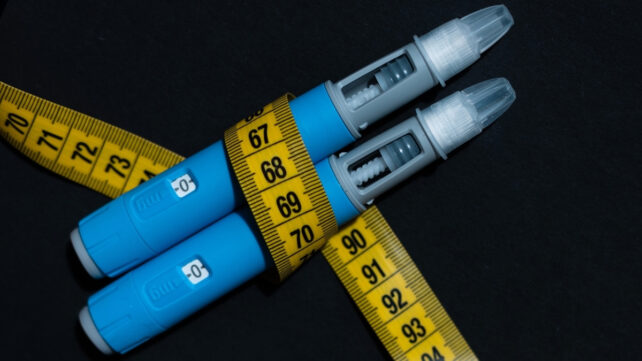 2 semaglutide pens wrapped in a tape measure