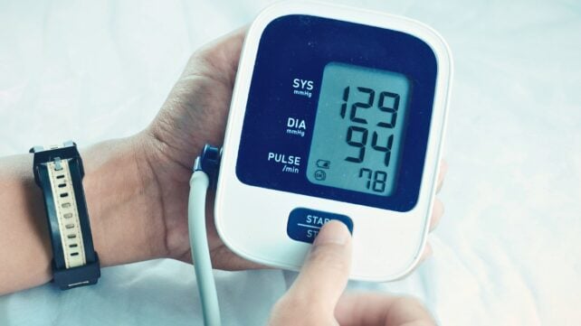 A blood pressure monitor in someone's hand