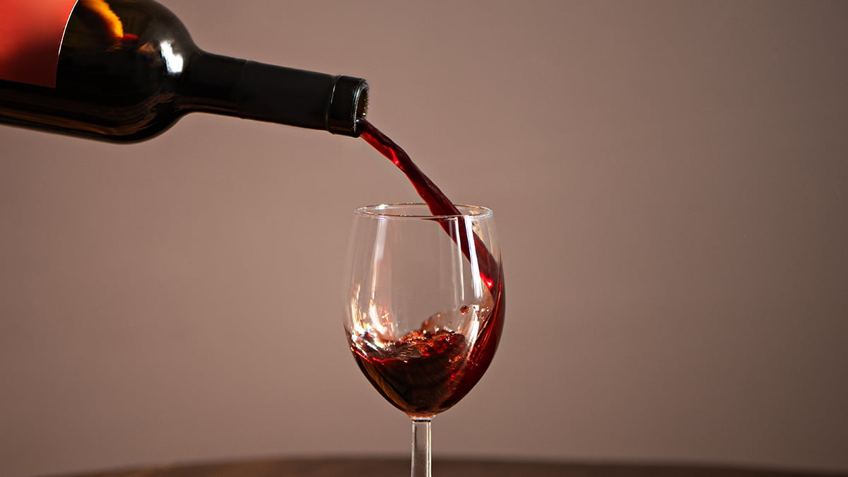 Red wine pouring into a glass
