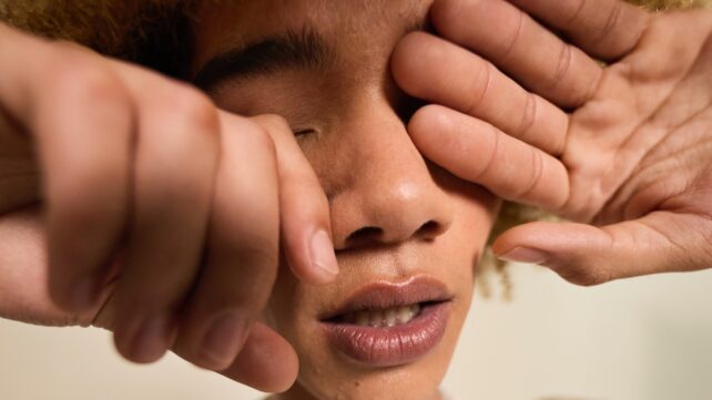 teen rubbing eyes