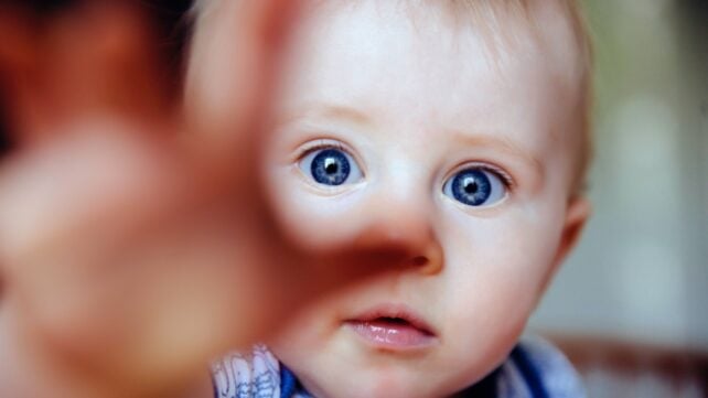Infant reaches out
