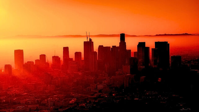 Captivating view of Los Angeles skyline with vibrant sunset hues and silhouette architecture