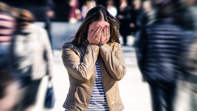 Someone overwhelmed in a crowd