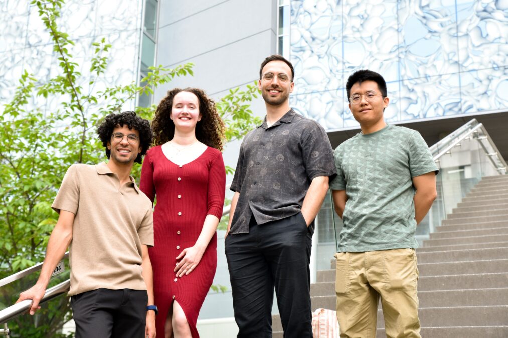 Four researchers involved in the organ-aging study standing together outside the CeMM research center.