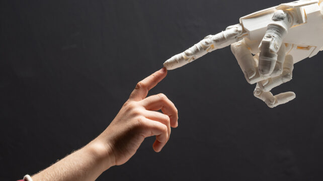 A robot hand touching a human hand