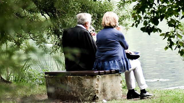 An elderly couple sitting down