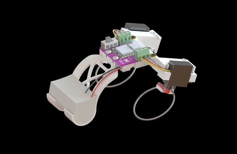 A palm-sized robot with electronic components and two looped elastic limbs against a black background.