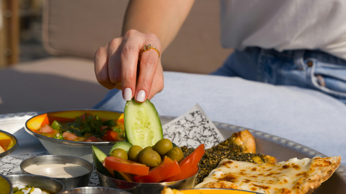 Close-up of a diverse Mediterranean breakfast with olives and vegetables outdoors