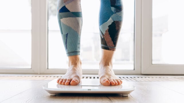 A person weighing themselves