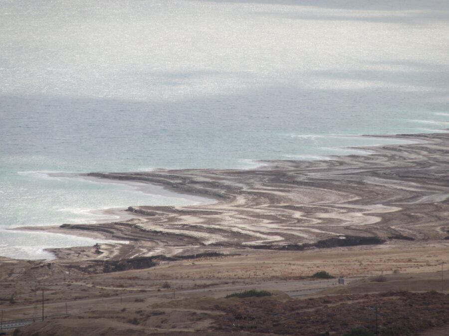 The Dead Sea's retreating shoreline covered with recent salt deposits.