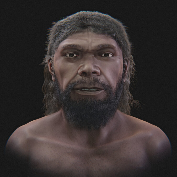 Front view of the Jebel Irhoud facial approximation with skin pigmentation, dark hair, and facial hair.
