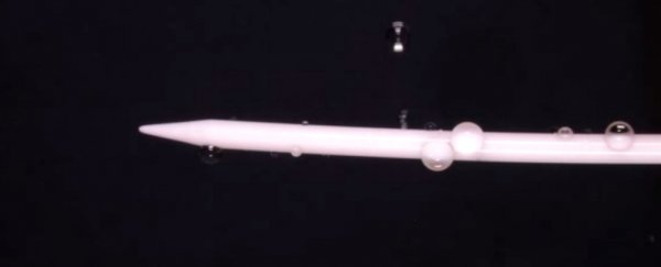 Watch a tiny water droplet 'orbit' a knitting needle
